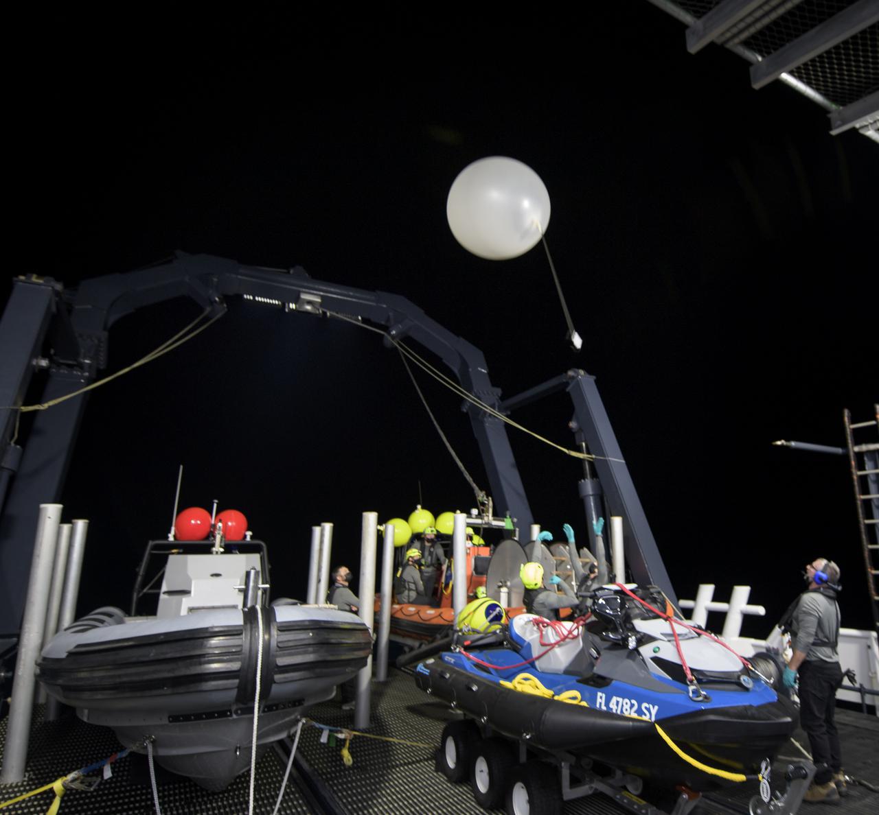 SpaceX support teams onboard the SpaceX GO Navigator recovery launch a weather balloon ahead of the landing of the SpaceX Crew Dragon Resilience spacecraft with NASA astronauts Mike Hopkins, Shannon Walker, and Victor Glover, and Japan Aerospace Exploration Agency (JAXA) astronaut Soichi Noguchi aboard in the Gulf of Mexico off the coast of Panama City, Florida, Saturday, May 1, 2021. NASA’s SpaceX Crew-1 mission is the first crew rotation flight of the SpaceX Crew Dragon spacecraft and Falcon 9 rocket with astronauts to the International Space Station as part of the agency’s Commercial Crew Program. Photo Credit: (NASA/Bill Ingalls)