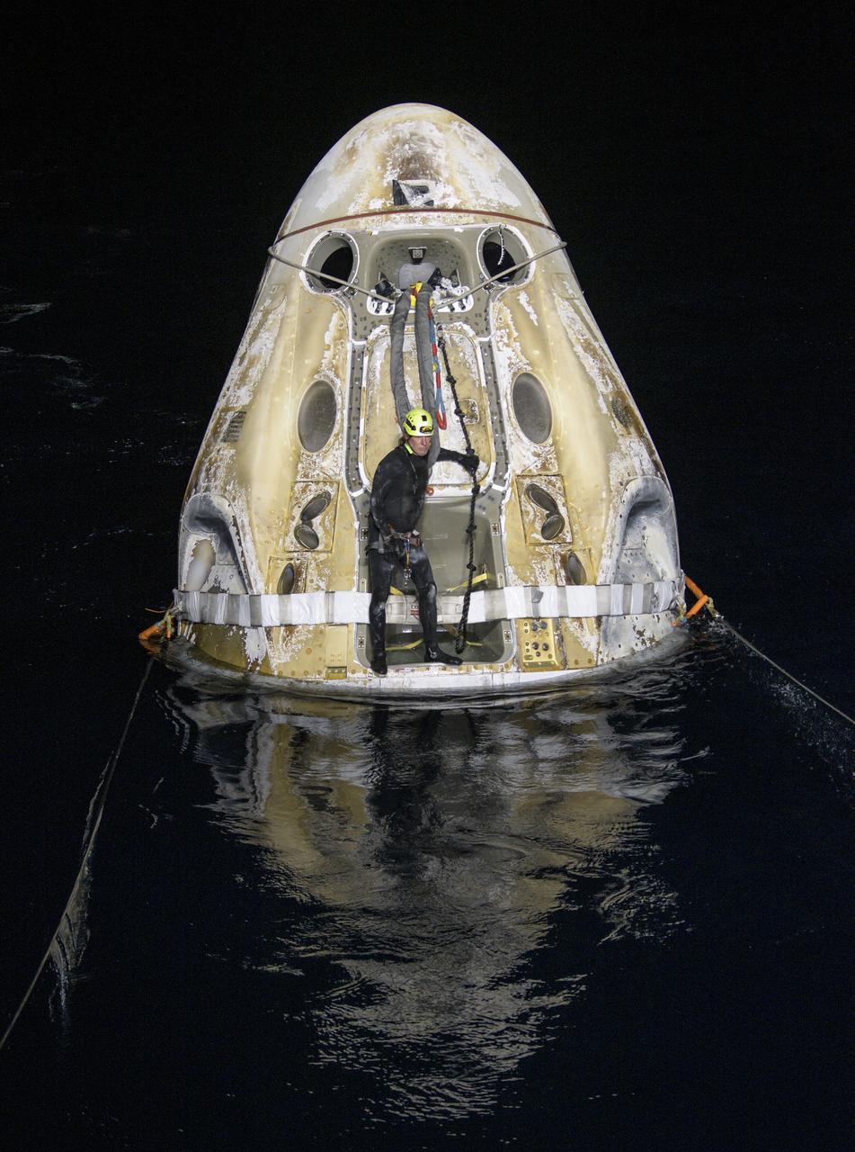 Support teams work around the SpaceX Crew Dragon Resilience spacecraft shortly after it landed with NASA astronauts Mike Hopkins, Shannon Walker, and Victor Glover, and Japan Aerospace Exploration Agency (JAXA) astronaut Soichi Noguchi aboard in the Gulf of Mexico off the coast of Panama City, Florida, Sunday, May 2, 2021.  NASA’s SpaceX Crew-1 mission was the first crew rotation flight of the SpaceX Crew Dragon spacecraft and Falcon 9 rocket with astronauts to the International Space Station as part of the agency’s Commercial Crew Program. Photo Credit: (NASA/Bill Ingalls)
