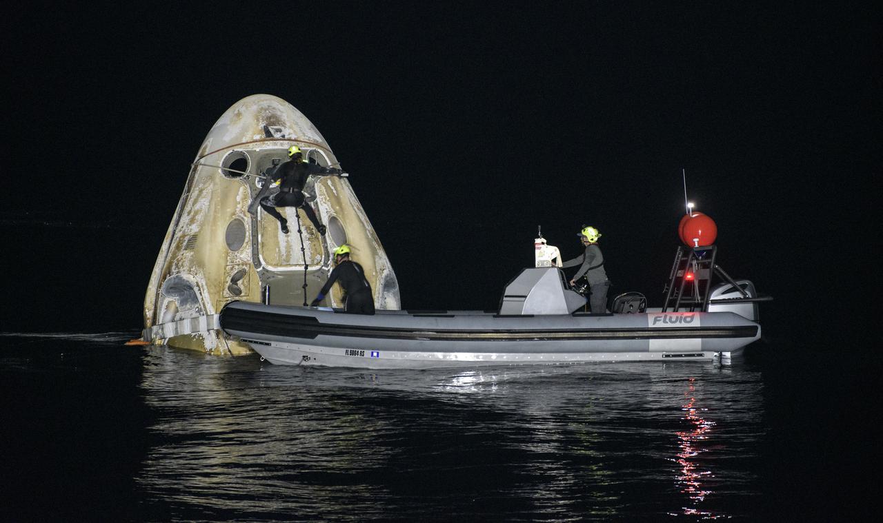 Support teams work around the SpaceX Crew Dragon Resilience spacecraft shortly after it landed with NASA astronauts Mike Hopkins, Shannon Walker, and Victor Glover, and Japan Aerospace Exploration Agency (JAXA) astronaut Soichi Noguchi aboard in the Gulf of Mexico off the coast of Panama City, Florida, Sunday, May 2, 2021. NASA’s SpaceX Crew-1 mission was the first crew rotation flight of the SpaceX Crew Dragon spacecraft and Falcon 9 rocket with astronauts to the International Space Station as part of the agency’s Commercial Crew Program. Photo Credit: (NASA/Bill Ingalls)