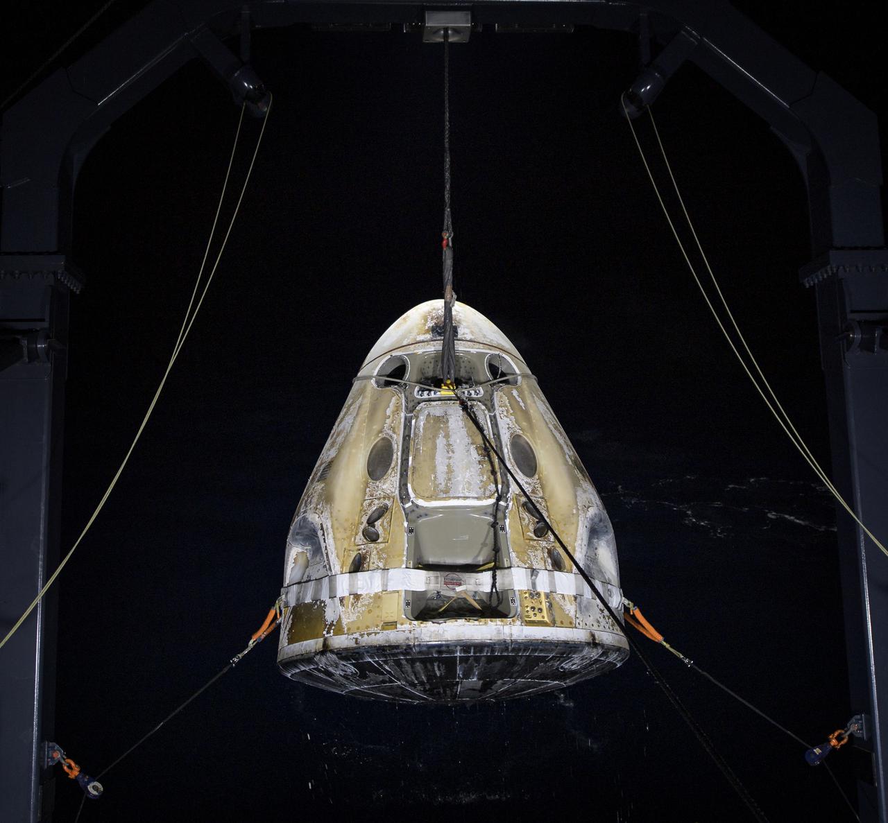 The SpaceX Crew Dragon Resilience spacecraft is lifted onto the GO Navigator recovery ship after it landed with NASA astronauts Mike Hopkins, Shannon Walker, and Victor Glover, and Japan Aerospace Exploration Agency (JAXA) astronaut Soichi Noguchi aboard in the Gulf of Mexico off the coast of Panama City, Florida, Sunday, May 2, 2021.  NASA’s SpaceX Crew-1 mission was the first crew rotation flight of the SpaceX Crew Dragon spacecraft and Falcon 9 rocket with astronauts to the International Space Station as part of the agency’s Commercial Crew Program. Photo Credit: (NASA/Bill Ingalls)