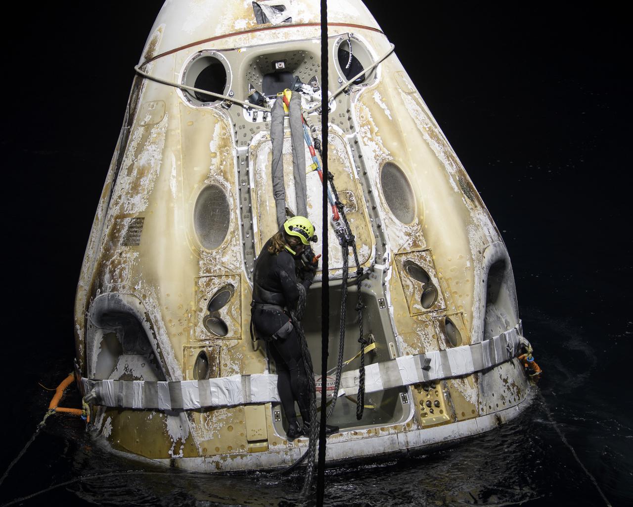 Support teams work around the SpaceX Crew Dragon Resilience spacecraft shortly after it landed with NASA astronauts Mike Hopkins, Shannon Walker, and Victor Glover, and Japan Aerospace Exploration Agency (JAXA) astronaut Soichi Noguchi aboard in the Gulf of Mexico off the coast of Panama City, Florida, Sunday, May 2, 2021. NASA’s SpaceX Crew-1 mission was the first crew rotation flight of the SpaceX Crew Dragon spacecraft and Falcon 9 rocket with astronauts to the International Space Station as part of the agency’s Commercial Crew Program. Photo Credit: (NASA/Bill Ingalls)