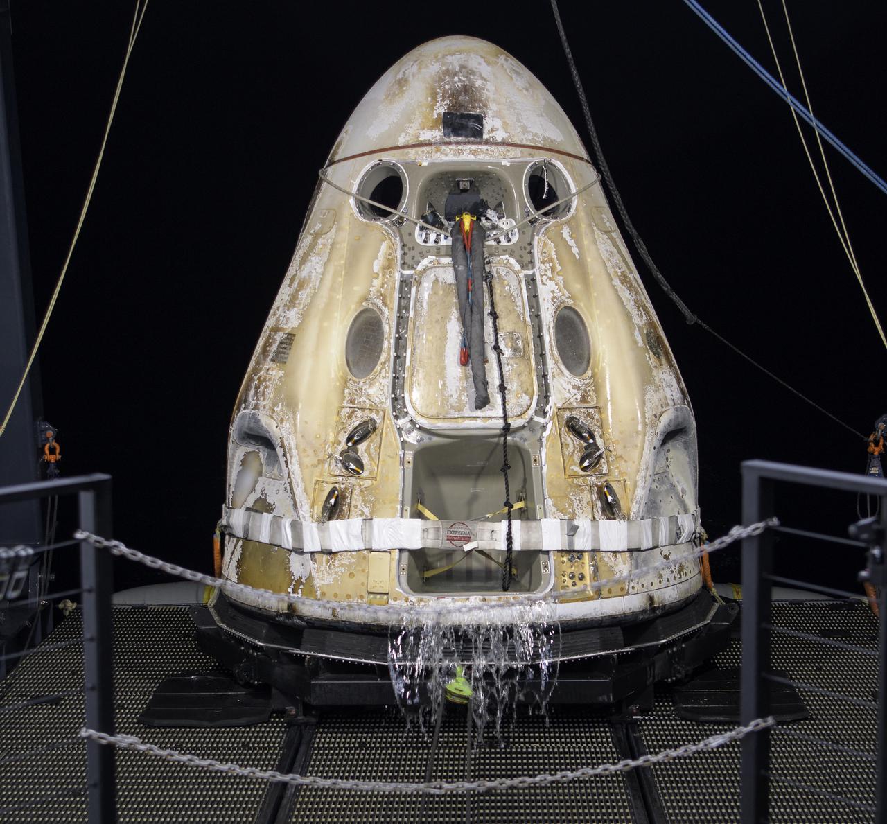 The SpaceX Crew Dragon Resilience spacecraft is lifted onto the GO Navigator recovery ship after it landed with NASA astronauts Mike Hopkins, Shannon Walker, and Victor Glover, and Japan Aerospace Exploration Agency (JAXA) astronaut Soichi Noguchi aboard in the Gulf of Mexico off the coast of Panama City, Florida, Sunday, May 2, 2021.  NASA’s SpaceX Crew-1 mission was the first crew rotation flight of the SpaceX Crew Dragon spacecraft and Falcon 9 rocket with astronauts to the International Space Station as part of the agency’s Commercial Crew Program. Photo Credit: (NASA/Bill Ingalls)