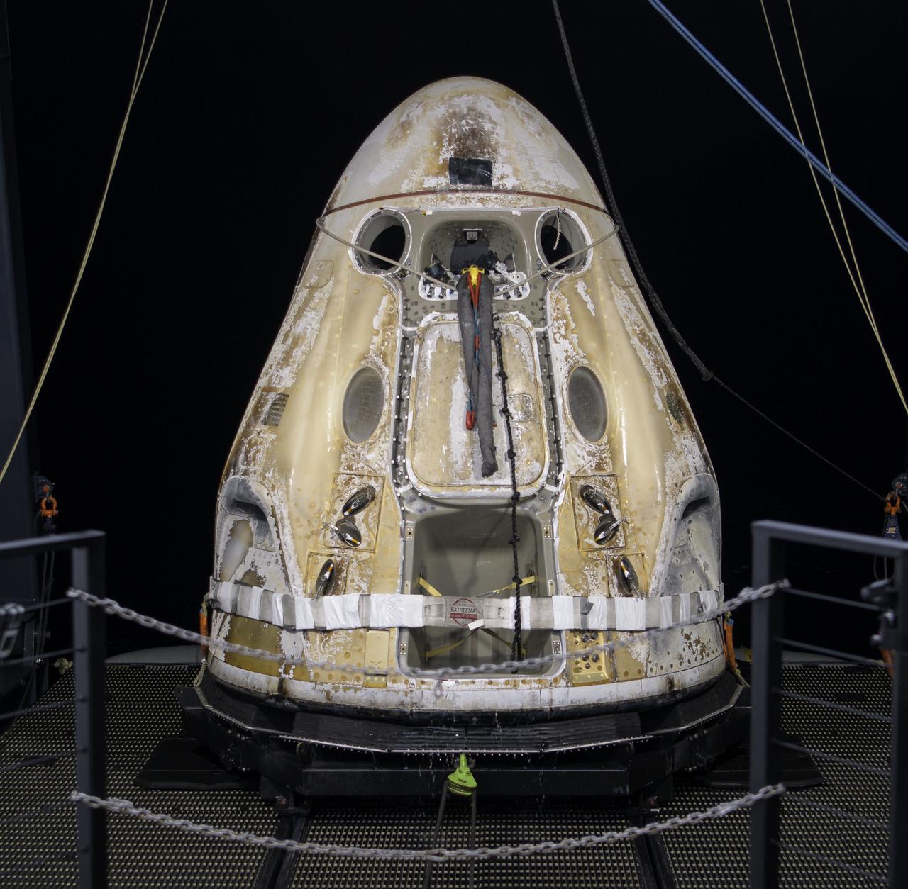 The SpaceX Crew Dragon Resilience spacecraft is lifted onto the GO Navigator recovery ship after it landed with NASA astronauts Mike Hopkins, Shannon Walker, and Victor Glover, and Japan Aerospace Exploration Agency (JAXA) astronaut Soichi Noguchi aboard in the Gulf of Mexico off the coast of Panama City, Florida, Sunday, May 2, 2021.  NASA’s SpaceX Crew-1 mission was the first crew rotation flight of the SpaceX Crew Dragon spacecraft and Falcon 9 rocket with astronauts to the International Space Station as part of the agency’s Commercial Crew Program. Photo Credit: (NASA/Bill Ingalls)
