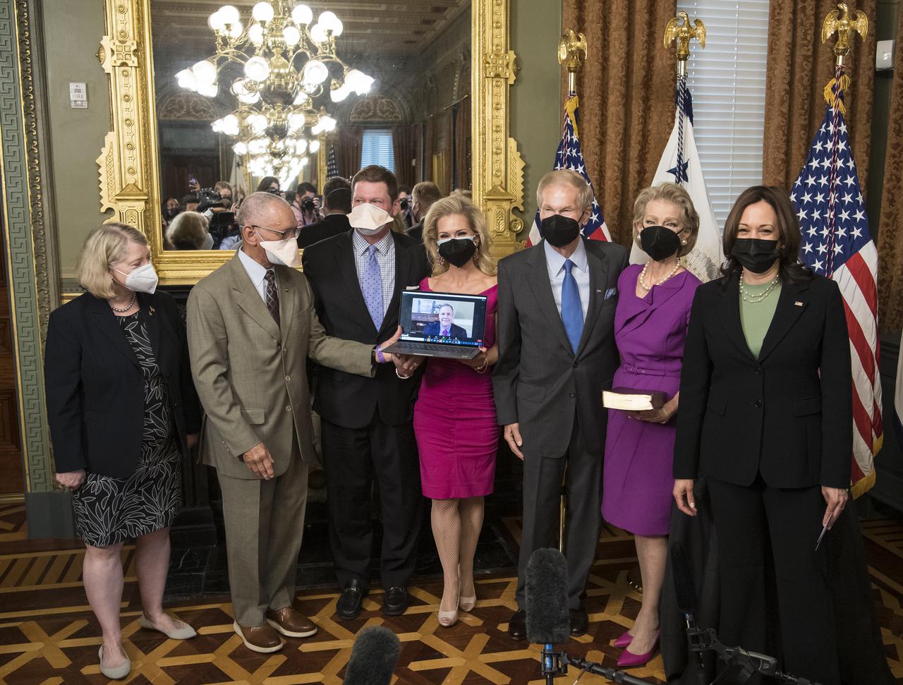 From left to right, Pam Melroy, current nominee for NASA Deputy Administrator, former NASA Administrator Charles Bolden, Bill Nelson Jr., son of Bill Nelson, Nan Ellen Nelson, daughter of Nelson, former Senator Bill Nelson, his wife, Grace Nelson, and Vice President Kamala Harris pose for a photo after Nelson was ceremonially sworn-in as the 14th NASA Administrator, Monday, May 3, 2021, at the Ceremonial Office in the Old Executive Office Building in Washington. A moon rock collected by astronaut John Young during the Apollo 16 mission was also on display. Photo Credit: (NASA/Aubrey Gemignani)