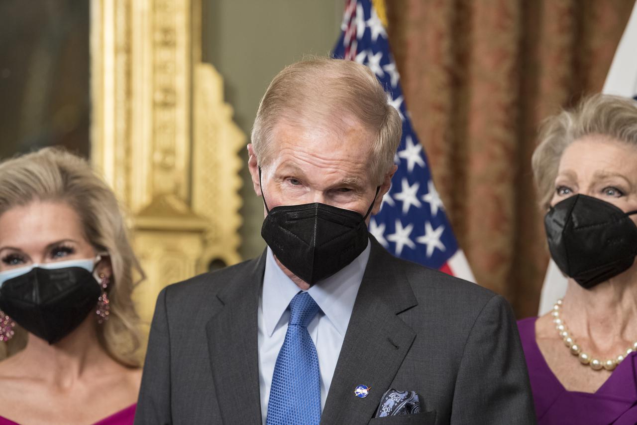 Former Senator Bill Nelson, speaks to media after he was ceremonially sworn-in as the 14th NASA Administrator by Vice President Kamala Harris, as his wife, Grace Nelson, right, held their family Bible, Monday, May 3, 2021, at the Ceremonial Office in the Old Executive Office Building in Washington. A moon rock collected by astronaut John Young during the Apollo 16 mission was on display and former NASA Administrators Jim Bridenstine (virtually on laptop) and Charles Bolden were also present. Photo Credit: (NASA/Aubrey Gemignani)