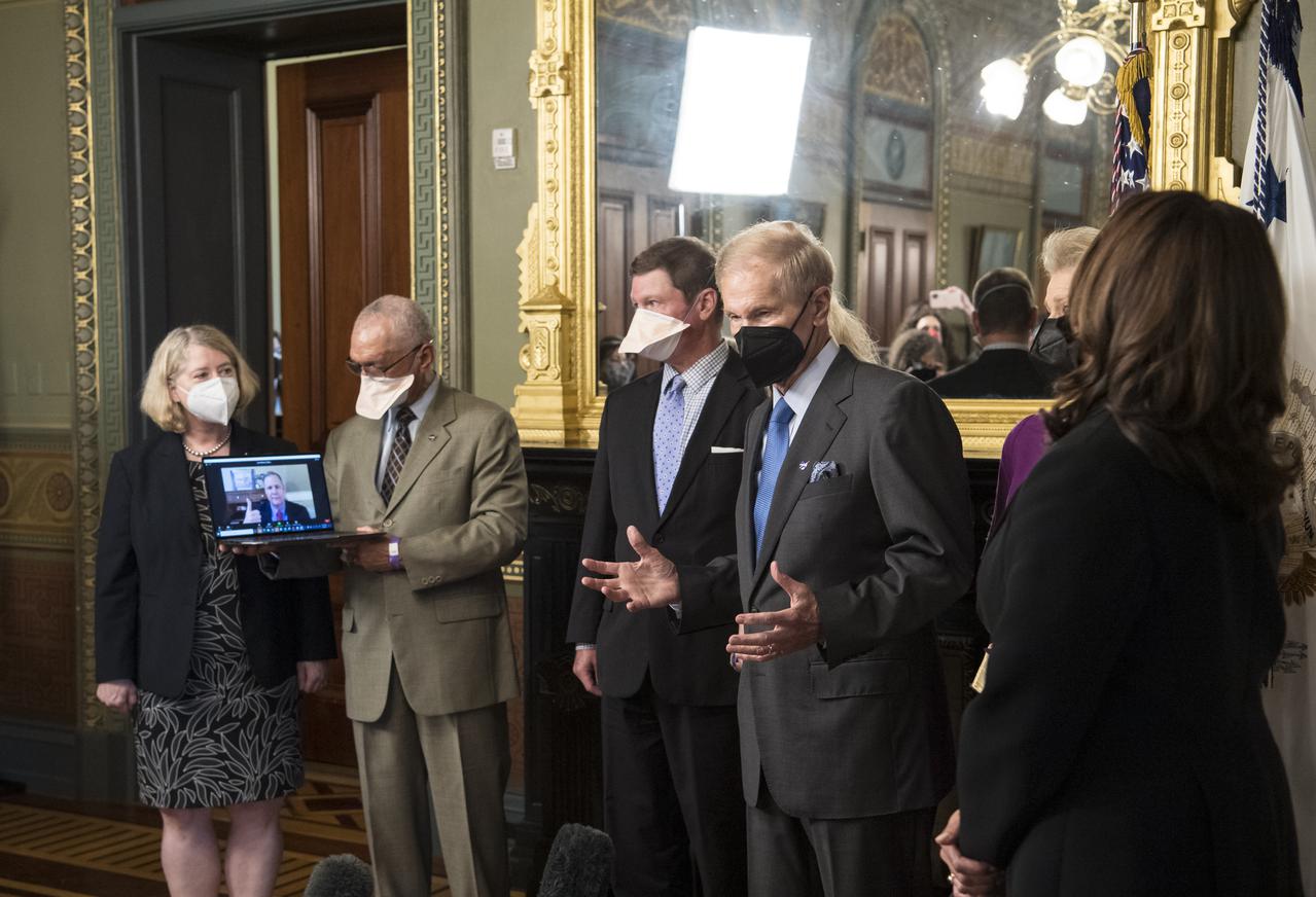 Former Senator Bill Nelson, speaks to media after he was ceremonially sworn-in as the 14th NASA Administrator by Vice President Kamala Harris, as his wife, Grace Nelson, held their family Bible, Monday, May 3, 2021, at the Ceremonial Office in the Old Executive Office Building in Washington. A moon rock collected by astronaut John Young during the Apollo 16 mission was on display and former NASA Administrators Jim Bridenstine (virtually on laptop) and Charles Bolden, second from left, as well as Pam Melroy, current nominee for NASA Deputy Administrator, left, were also present. Photo Credit: (NASA/Aubrey Gemignani)