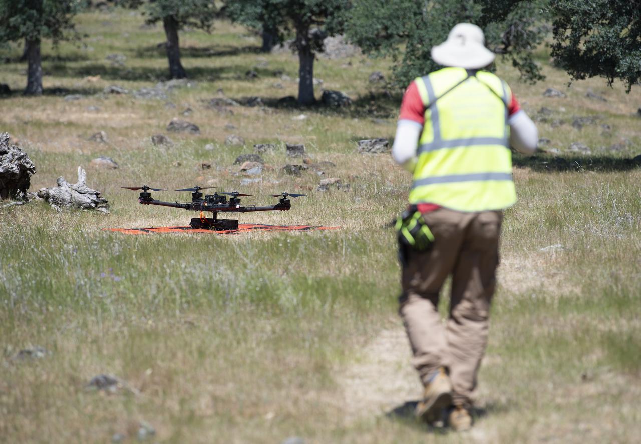 Jonas Jonsson, pilot in command for STEReO, the Scalable Traffic Management for Emergency Response Operations project, at NASA's Ames Research Center, performs final checks on a FreeFly Systems Alta X drone prior to a flight during STEReO test activities, Tuesday, May 4, 2021 as Cal Fire conducts aerial fire fighting training exercises near Redding, California. STEReO, the Scalable Traffic Management for Emergency Response Operations project, led by NASA’s Ames Research Center, builds on NASA’s expertise in air traffic management, human factors research, and autonomous technology development to apply the agency’s work in Unmanned Aircraft Systems Traffic Management, or UTM, to public safety uses. Photo Credit: (NASA/Joel Kowsky)