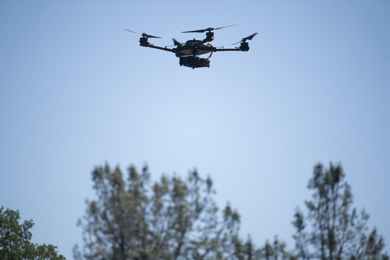A FreeFly Systems Alta X drone is seen in flight during STEReO, the Scalable Traffic Management for Emergency Response Operations project, test activities, Tuesday, May 4, 2021 as Cal Fire conducts aerial fire fighting training exercises near Redding, California.  STEReO, the Scalable Traffic Management for Emergency Response Operations project, led by NASA’s Ames Research Center, builds on NASA’s expertise in air traffic management, human factors research, and autonomous technology development to apply the agency’s work in Unmanned Aircraft Systems Traffic Management, or UTM, to public safety uses. Photo Credit: (NASA/Joel Kowsky)