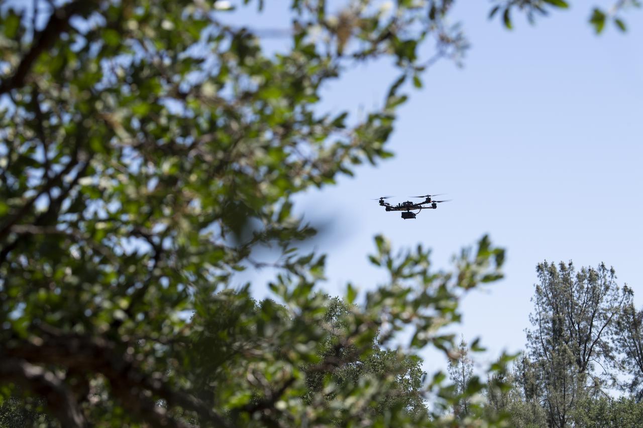 A FreeFly Systems Alta X drone is seen in flight during STEReO, the Scalable Traffic Management for Emergency Response Operations project, test activities, Tuesday, May 4, 2021 as Cal Fire conducts aerial fire fighting training exercises near Redding, California.  STEReO, the Scalable Traffic Management for Emergency Response Operations project, led by NASA’s Ames Research Center, builds on NASA’s expertise in air traffic management, human factors research, and autonomous technology development to apply the agency’s work in Unmanned Aircraft Systems Traffic Management, or UTM, to public safety uses. Photo Credit: (NASA/Joel Kowsky)