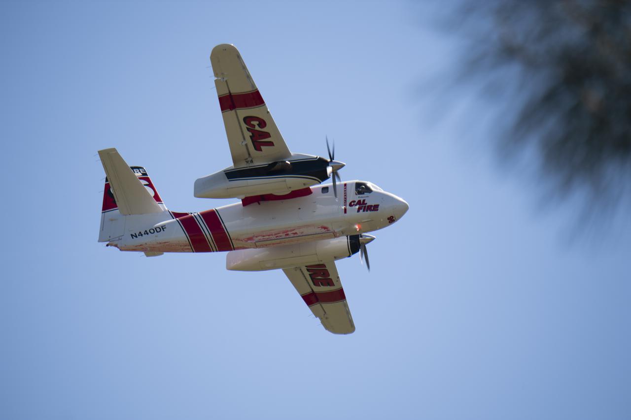 A Cal Fire S2-T airtanker is seen during an aerial attack on a simulated wildfire, Tuesday, May 4, 2021 as Cal Fire conducts aerial fire fighting training exercises near Redding, California.  STEReO, the Scalable Traffic Management for Emergency Response Operations project, led by NASA’s Ames Research Center, builds on NASA’s expertise in air traffic management, human factors research, and autonomous technology development to apply the agency’s work in Unmanned Aircraft Systems Traffic Management, or UTM, to public safety uses. Photo Credit: (NASA/Joel Kowsky)