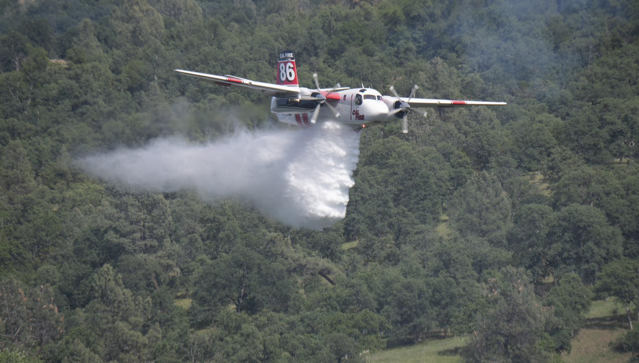 A Cal Fire S2-T airtanker drops water on a simulated wildfire, Tuesday, May 4, 2021, as Cal Fire conducts aerial fire fighting training exercises near Redding, California. STEReO, the Scalable Traffic Management for Emergency Response Operations project, led by NASA’s Ames Research Center, builds on NASA’s expertise in air traffic management, human factors research, and autonomous technology development to apply the agency’s work in Unmanned Aircraft Systems Traffic Management, or UTM, to public safety uses. Photo Credit: (NASA/Joel Kowsky)