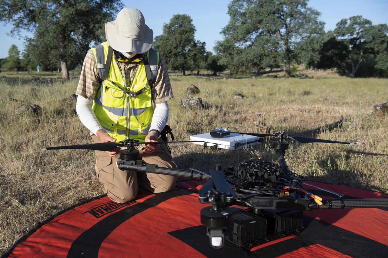 Jonas Jonsson, pilot in command for STEReO, the Scalable Traffic Management for Emergency Response Operations project, at NASA's Ames Research Center, performs pre-flight checks on a FreeFly Systems Alta X drone, Wednesday, May 5, 2021 as Cal Fire conducts aerial fire fighting training exercises near Redding, California.  STEReO, the Scalable Traffic Management for Emergency Response Operations project, led by NASA’s Ames Research Center, builds on NASA’s expertise in air traffic management, human factors research, and autonomous technology development to apply the agency’s work in Unmanned Aircraft Systems Traffic Management, or UTM, to public safety uses. Photo Credit: (NASA/Joel Kowsky)