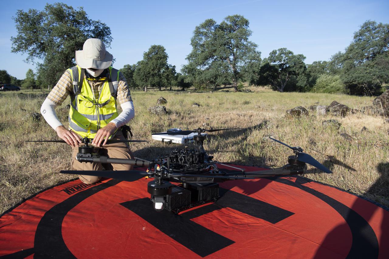 Jonas Jonsson, pilot in command for STEReO, the Scalable Traffic Management for Emergency Response Operations project, at NASA's Ames Research Center, performs pre-flight checks on a FreeFly Systems Alta X drone, Wednesday, May 5, 2021 as Cal Fire conducts aerial fire fighting training exercises near Redding, California.  STEReO, the Scalable Traffic Management for Emergency Response Operations project, led by NASA’s Ames Research Center, builds on NASA’s expertise in air traffic management, human factors research, and autonomous technology development to apply the agency’s work in Unmanned Aircraft Systems Traffic Management, or UTM, to public safety uses. Photo Credit: (NASA/Joel Kowsky)