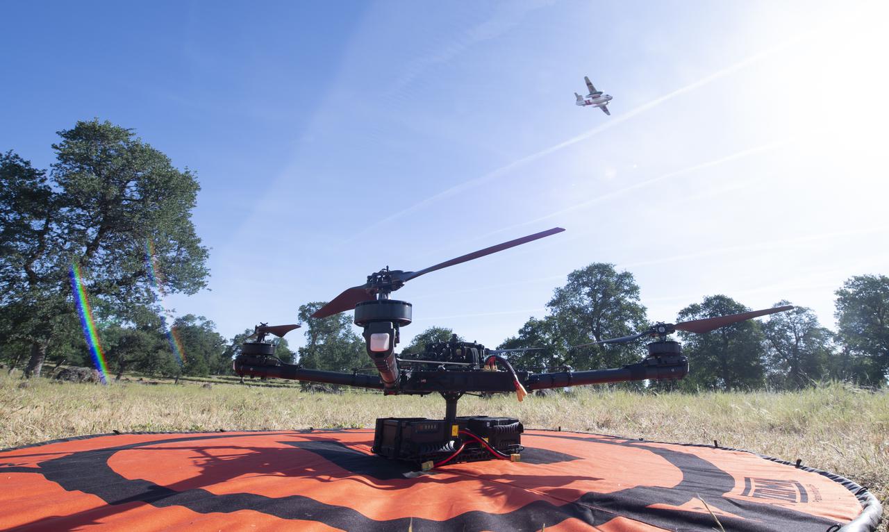 A Cal Fire S2-T airtanker is seen flying past the FreeFly Systems Alta X drone used during STEReO, the Scalable Traffic Management for Emergency Response Operations project, test activities, Wednesday, May 5, 2021 as Cal Fire conducts aerial fire fighting training exercises near Redding, California.  STEReO, the Scalable Traffic Management for Emergency Response Operations project, led by NASA’s Ames Research Center, builds on NASA’s expertise in air traffic management, human factors research, and autonomous technology development to apply the agency’s work in Unmanned Aircraft Systems Traffic Management, or UTM, to public safety uses. Photo Credit: (NASA/Joel Kowsky)