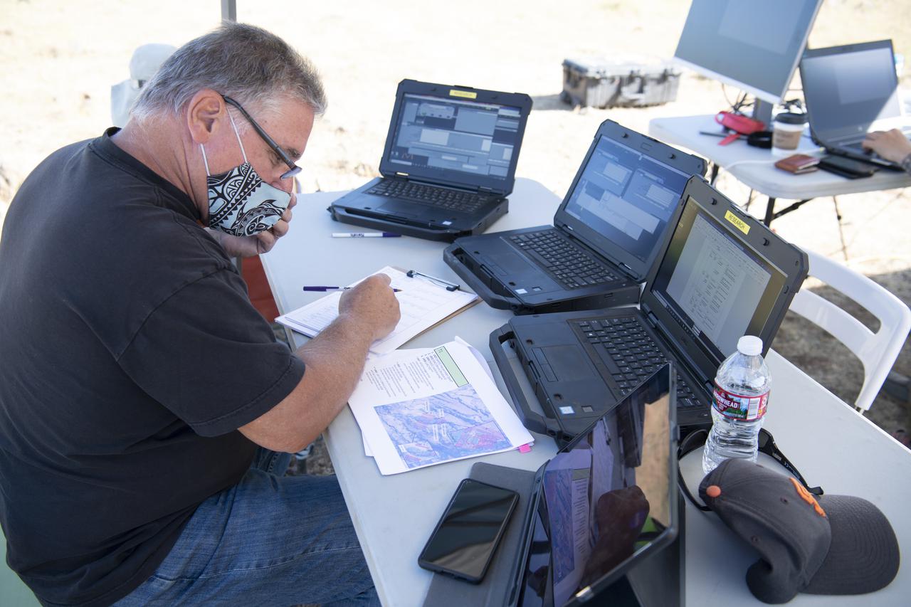 Bill McCarthy, software engineer and research laptop operator for STEReO, the Scalable Traffic Management for Emergency Response Operations project, at NASA's Ames Research Center, is seen during simulated drone operations as part of STEReO field testing, Wednesday, May 5, 2021 as Cal Fire conducts aerial fire fighting training exercises near Redding, California.  STEReO, the Scalable Traffic Management for Emergency Response Operations project, led by NASA’s Ames Research Center, builds on NASA’s expertise in air traffic management, human factors research, and autonomous technology development to apply the agency’s work in Unmanned Aircraft Systems Traffic Management, or UTM, to public safety uses. Photo Credit: (NASA/Joel Kowsky)