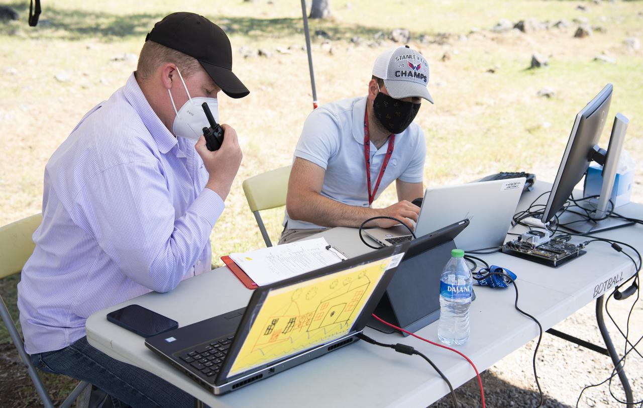 Robert McSwain, co-principle investigator and autonomy researcher for STEReO, the Scalable Traffic Management for Emergency Response Operations project, at NASA's Langley Research Center, left, and Bryan Petty, autonomy researcher for STEReO, the Scalable Traffic Management for Emergency Response Operations project, at NASA's Langley Research Center, right, are seen during simulated drone operations as part of STEReO field testing, Wednesday, May 5, 2021 as Cal Fire conducts aerial fire fighting training exercises near Redding, California.  STEReO, the Scalable Traffic Management for Emergency Response Operations project, led by NASA’s Ames Research Center, builds on NASA’s expertise in air traffic management, human factors research, and autonomous technology development to apply the agency’s work in Unmanned Aircraft Systems Traffic Management, or UTM, to public safety uses. Photo Credit: (NASA/Joel Kowsky)