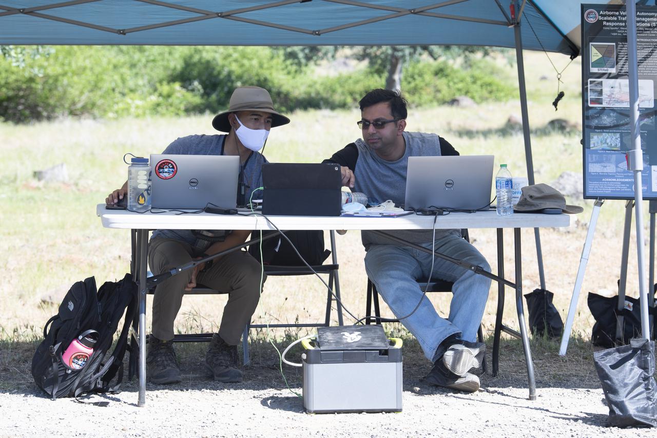 Josh Baculi, autonomy researcher for STEReO, the Scalable Traffic Management for Emergency Response Operations project, at NASA's Ames Research Center, left, and Anjan Chakrabarty, autonomy researcher for STEReO, the Scalable Traffic Management for Emergency Response Operations project, at NASA's Ames Research Center, right, are seen during simulated drone operations as part of STEReO field testing, Wednesday, May 5, 2021 as Cal Fire conducts aerial fire fighting training exercises near Redding, California. STEReO, the Scalable Traffic Management for Emergency Response Operations project, led by NASA’s Ames Research Center, builds on NASA’s expertise in air traffic management, human factors research, and autonomous technology development to apply the agency’s work in Unmanned Aircraft Systems Traffic Management, or UTM, to public safety uses. Photo Credit: (NASA/Joel Kowsky)