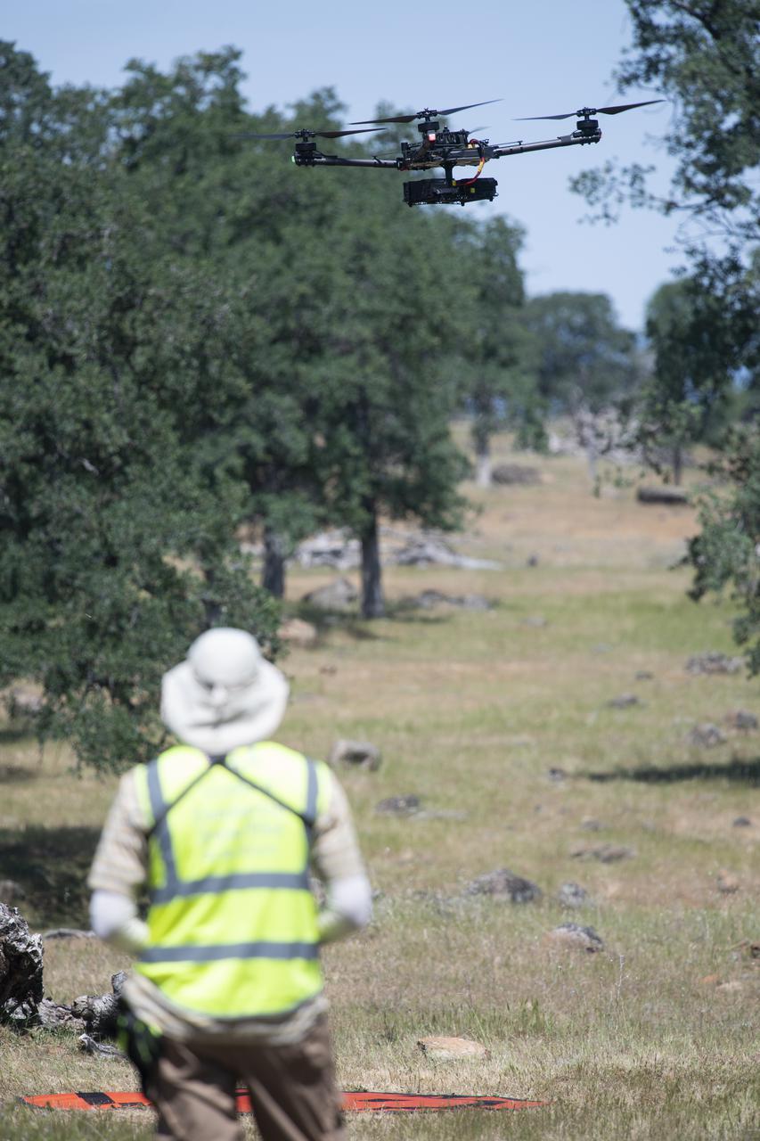 A FreeFly Systems Alta X drone is seen in flight under the control of Jonas Jonsson, pilot in command for STEReO, the Scalable Traffic Management for Emergency Response Operations project, at NASA's Ames Research Center, as part of STEReO test activities, Wednesday, May 5, 2021 as Cal Fire conducts aerial fire fighting training exercises near Redding, California. STEReO, the Scalable Traffic Management for Emergency Response Operations project, led by NASA’s Ames Research Center, builds on NASA’s expertise in air traffic management, human factors research, and autonomous technology development to apply the agency’s work in Unmanned Aircraft Systems Traffic Management, or UTM, to public safety uses. Photo Credit: (NASA/Joel Kowsky)