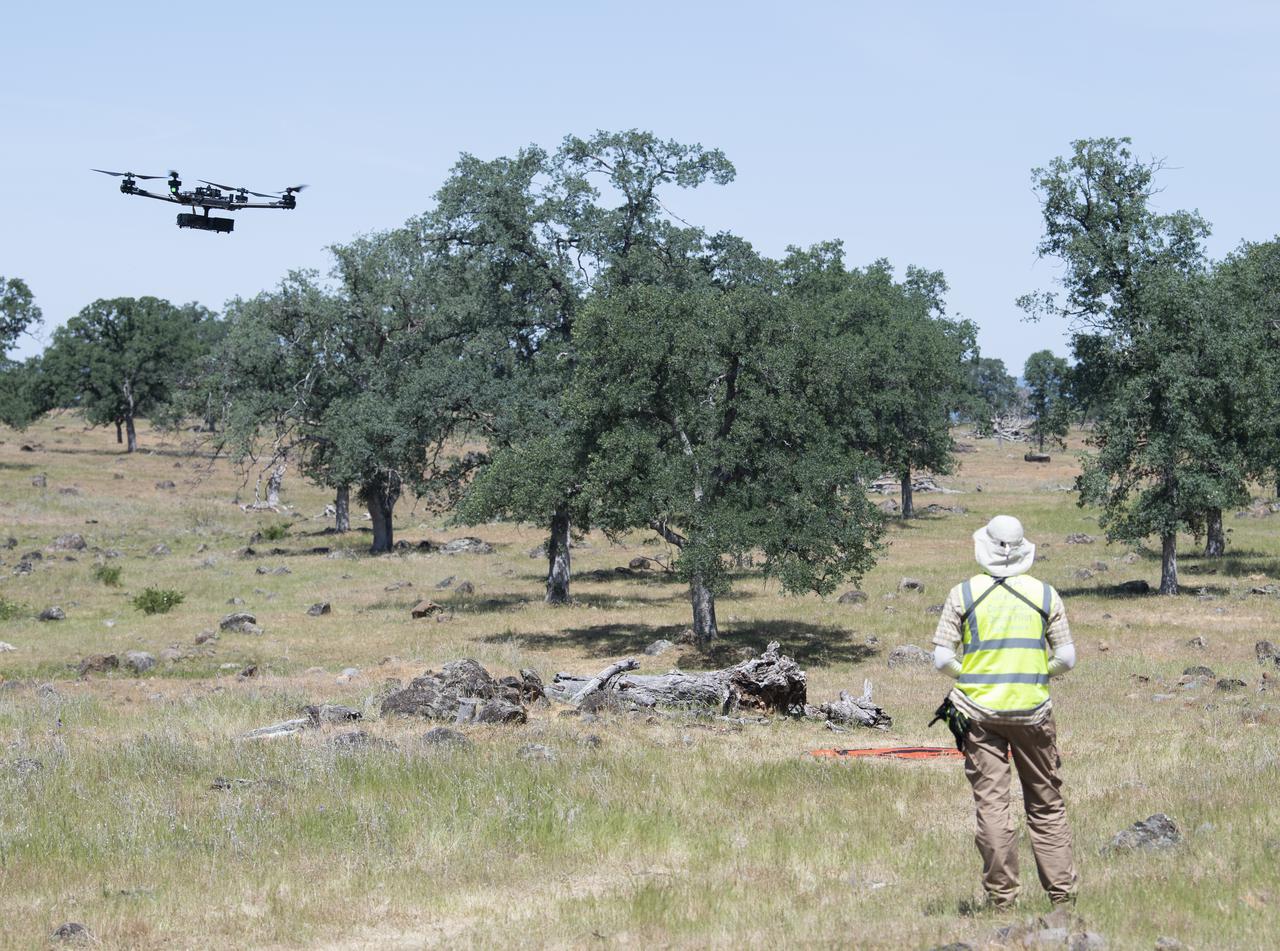 A FreeFly Systems Alta X drone is seen in flight under the control of Jonas Jonsson, pilot in command for STEReO, the Scalable Traffic Management for Emergency Response Operations project, at NASA's Ames Research Center, as part of STEReO test activities, Wednesday, May 5, 2021 as Cal Fire conducts aerial fire fighting training exercises near Redding, California. STEReO, the Scalable Traffic Management for Emergency Response Operations project, led by NASA’s Ames Research Center, builds on NASA’s expertise in air traffic management, human factors research, and autonomous technology development to apply the agency’s work in Unmanned Aircraft Systems Traffic Management, or UTM, to public safety uses. Photo Credit: (NASA/Joel Kowsky)
