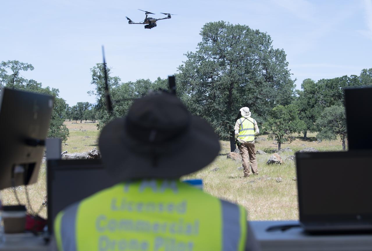 A FreeFly Systems Alta X drone is seen in flight under the control of Jonas Jonsson, pilot in command for STEReO, the Scalable Traffic Management for Emergency Response Operations project, at NASA's Ames Research Center, as part of STEReO test activities, Wednesday, May 5, 2021 as Cal Fire conducts aerial fire fighting training exercises near Redding, California. STEReO, the Scalable Traffic Management for Emergency Response Operations project, led by NASA’s Ames Research Center, builds on NASA’s expertise in air traffic management, human factors research, and autonomous technology development to apply the agency’s work in Unmanned Aircraft Systems Traffic Management, or UTM, to public safety uses. Photo Credit: (NASA/Joel Kowsky)