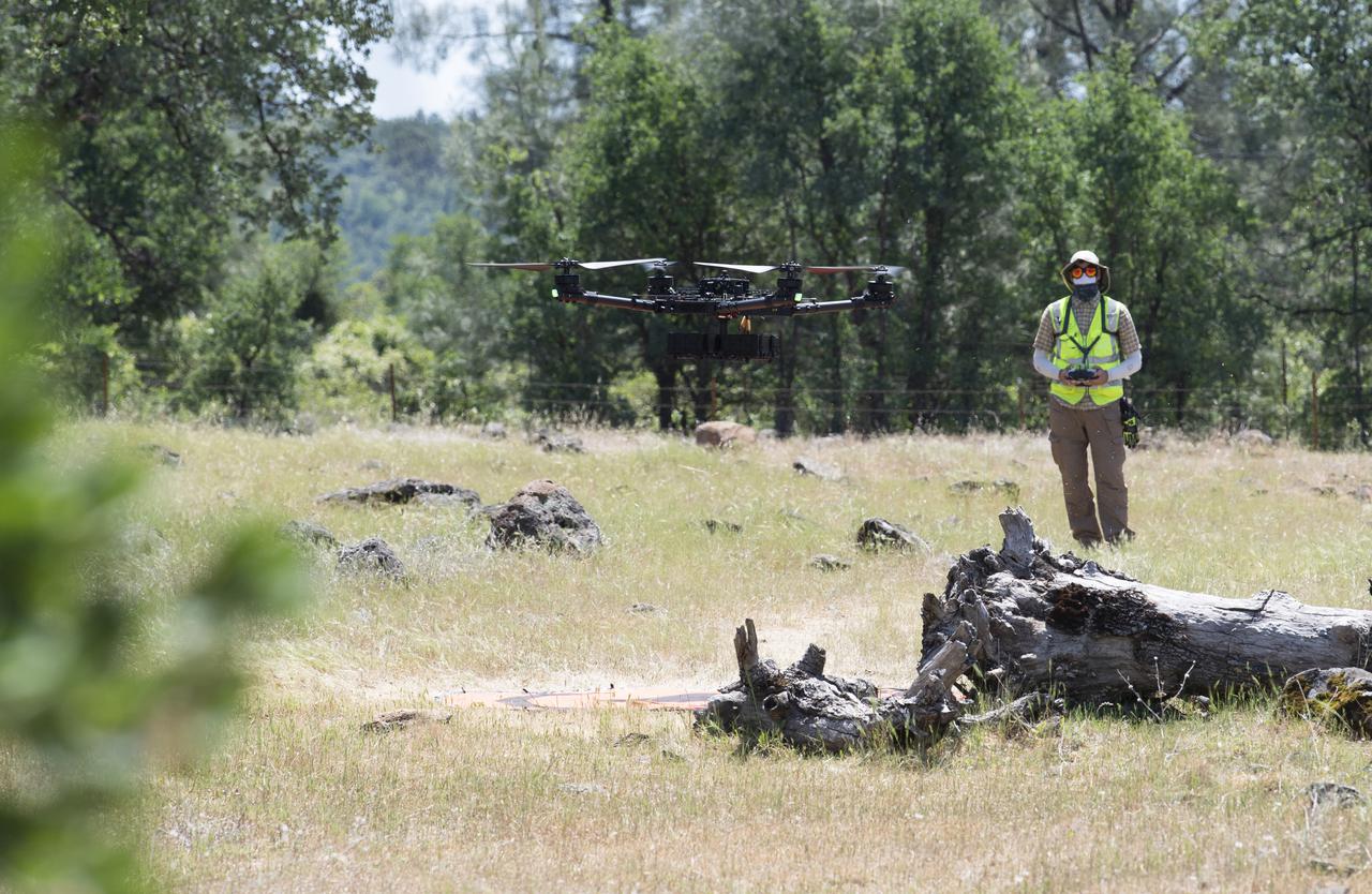 A FreeFly Systems Alta X drone is seen in flight under the control of Jonas Jonsson, pilot in command for STEReO, the Scalable Traffic Management for Emergency Response Operations project, at NASA's Ames Research Center, as part of STEReO test activities, Wednesday, May 5, 2021 as Cal Fire conducts aerial fire fighting training exercises near Redding, California. STEReO, the Scalable Traffic Management for Emergency Response Operations project, led by NASA’s Ames Research Center, builds on NASA’s expertise in air traffic management, human factors research, and autonomous technology development to apply the agency’s work in Unmanned Aircraft Systems Traffic Management, or UTM, to public safety uses. Photo Credit: (NASA/Joel Kowsky)