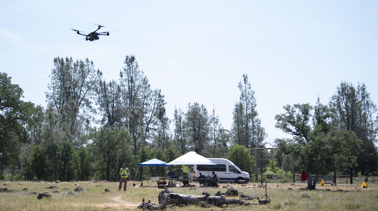 A FreeFly Systems Alta X drone is seen in flight under the control of Jonas Jonsson, pilot in command for STEReO, the Scalable Traffic Management for Emergency Response Operations project, at NASA's Ames Research Center, as part of STEReO test activities, Wednesday, May 5, 2021 as Cal Fire conducts aerial fire fighting training exercises near Redding, California. STEReO, the Scalable Traffic Management for Emergency Response Operations project, led by NASA’s Ames Research Center, builds on NASA’s expertise in air traffic management, human factors research, and autonomous technology development to apply the agency’s work in Unmanned Aircraft Systems Traffic Management, or UTM, to public safety uses. Photo Credit: (NASA/Joel Kowsky)