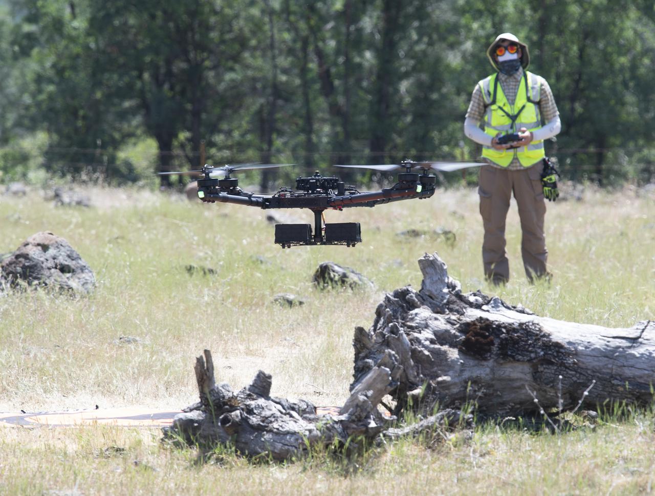 A FreeFly Systems Alta X drone is seen in flight under the control of Jonas Jonsson, pilot in command for STEReO, the Scalable Traffic Management for Emergency Response Operations project, at NASA's Ames Research Center, as part of STEReO test activities, Wednesday, May 5, 2021 as Cal Fire conducts aerial fire fighting training exercises near Redding, California. STEReO, the Scalable Traffic Management for Emergency Response Operations project, led by NASA’s Ames Research Center, builds on NASA’s expertise in air traffic management, human factors research, and autonomous technology development to apply the agency’s work in Unmanned Aircraft Systems Traffic Management, or UTM, to public safety uses. Photo Credit: (NASA/Joel Kowsky)