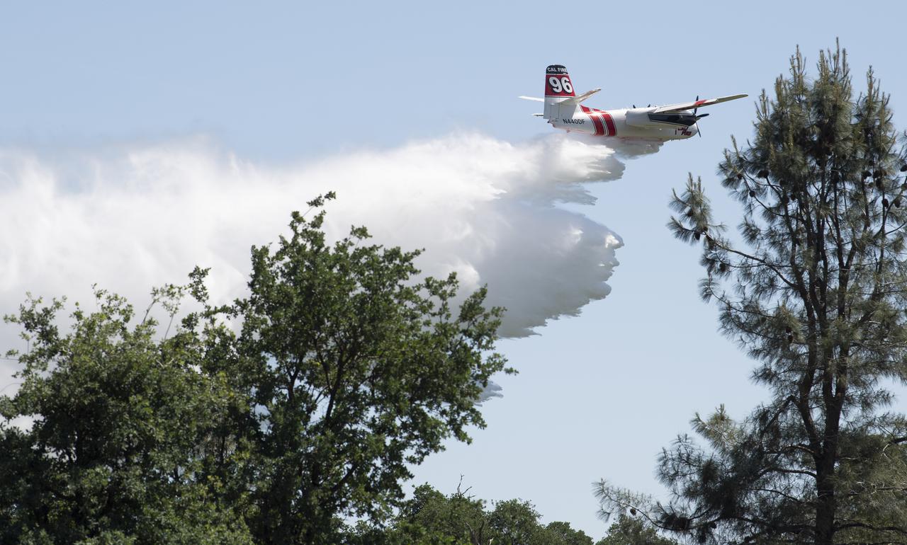 A Cal Fire S2-T airtanker drops water on a simulated wildfire, Wednesday, May 5, 2021 as Cal Fire conducts aerial fire fighting training exercises near Redding, California. STEReO, the Scalable Traffic Management for Emergency Response Operations project, led by NASA’s Ames Research Center, builds on NASA’s expertise in air traffic management, human factors research, and autonomous technology development to apply the agency’s work in Unmanned Aircraft Systems Traffic Management, or UTM, to public safety uses. Photo Credit: (NASA/Joel Kowsky)
