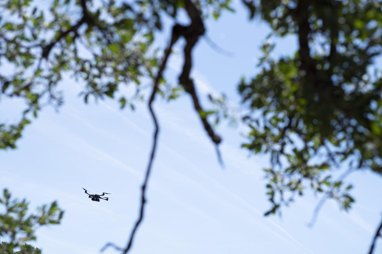 A FreeFly Systems Alta X drone is seen in flight during STEReO, the Scalable Traffic Management for Emergency Response Operations project, field testing, Wednesday, May 5, 2021 as Cal Fire conducts aerial fire fighting training exercises near Redding, California.  STEReO, the Scalable Traffic Management for Emergency Response Operations project, led by NASA’s Ames Research Center, builds on NASA’s expertise in air traffic management, human factors research, and autonomous technology development to apply the agency’s work in Unmanned Aircraft Systems Traffic Management, or UTM, to public safety uses. Photo Credit: (NASA/Joel Kowsky)