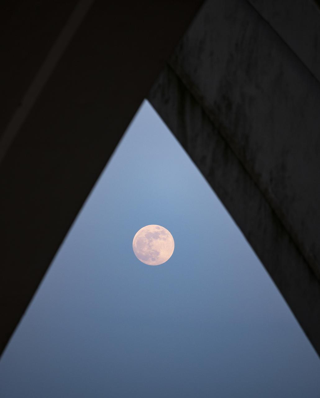 Moonrise, Tuesday, May 25, 2021, as seen from under the Woodrow Wilson Memorial Bridge in Alexandria, Virginia. Photo Credit: (NASA/Bill Ingalls)