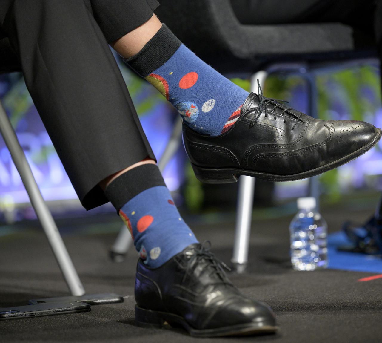 The socks of NASA Associate Administrator for Science Thomas Zurbuchen are seen as he answers a reporter’s question during a media gaggle, Wednesday, June 2, 2021, at NASA Headquarters Mary W. Jackson Building in Washington. Zurbuchen, along with  NASA Administrator Bill Nelson and other NASA leadership, answered reporters questions following a State of NASA event where Nelson remarked on his long history with NASA, and among other topics, discussed the agency’s plans for future Earth-focused missions to address climate change and a robotic and human return to the Moon through the Artemis program, as well as announcing two new planetary science missions to Venus – VERITAS and DAVINCI+. Photo Credit: (NASA/Bill Ingalls)
