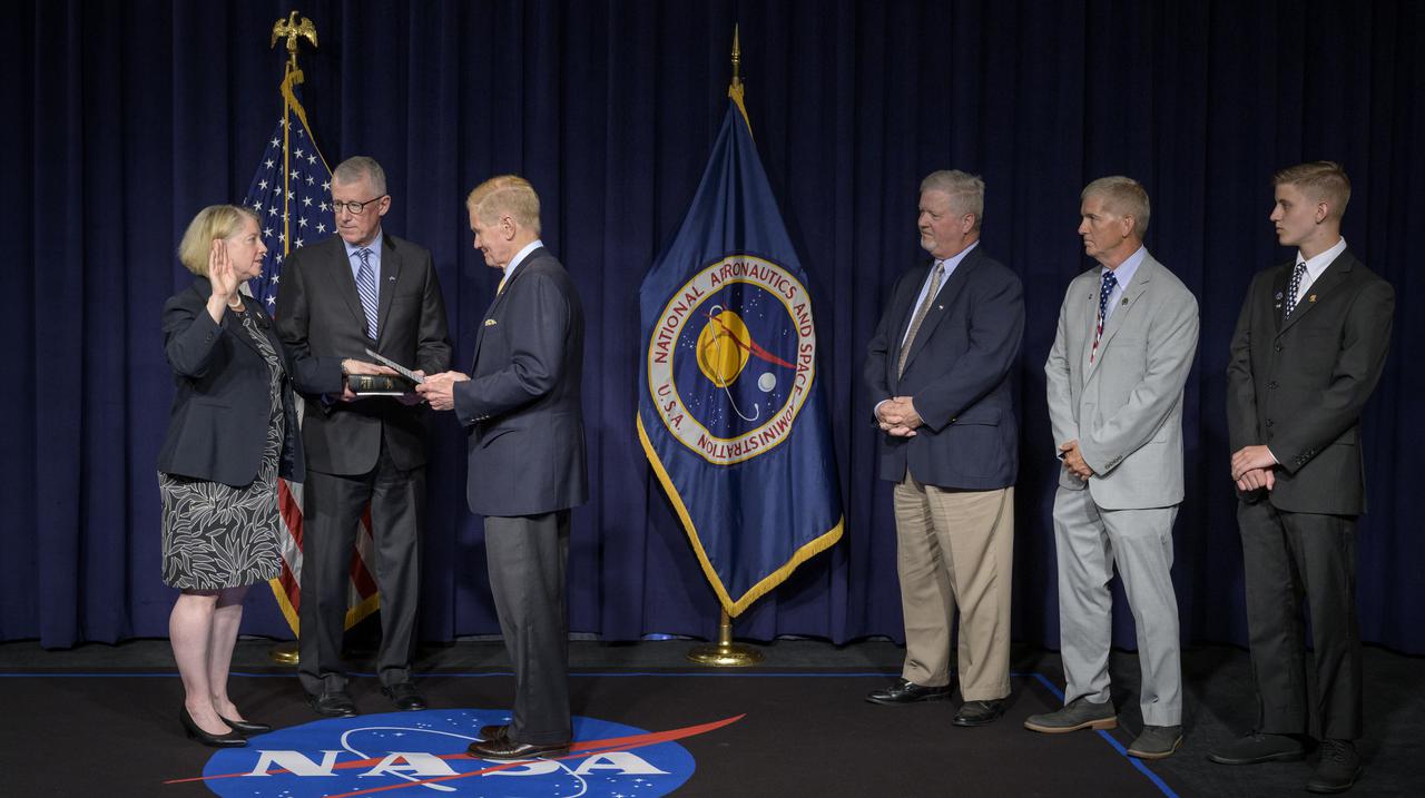 Pam Melroy is ceremonially sworn-in as the 15th NASA Deputy Administrator by NASA Administrator Bill Nelson, as her husband Douglas Hollett, holds their family Bible, and her brothers David, Stephen and her nephew Ryan, right, look on, Monday, June 21, 2021, at NASA Headquarters Mary W. Jackson Building in Washington. Melroy is a former NASA astronaut. Photo Credit: (NASA/Bill Ingalls)
