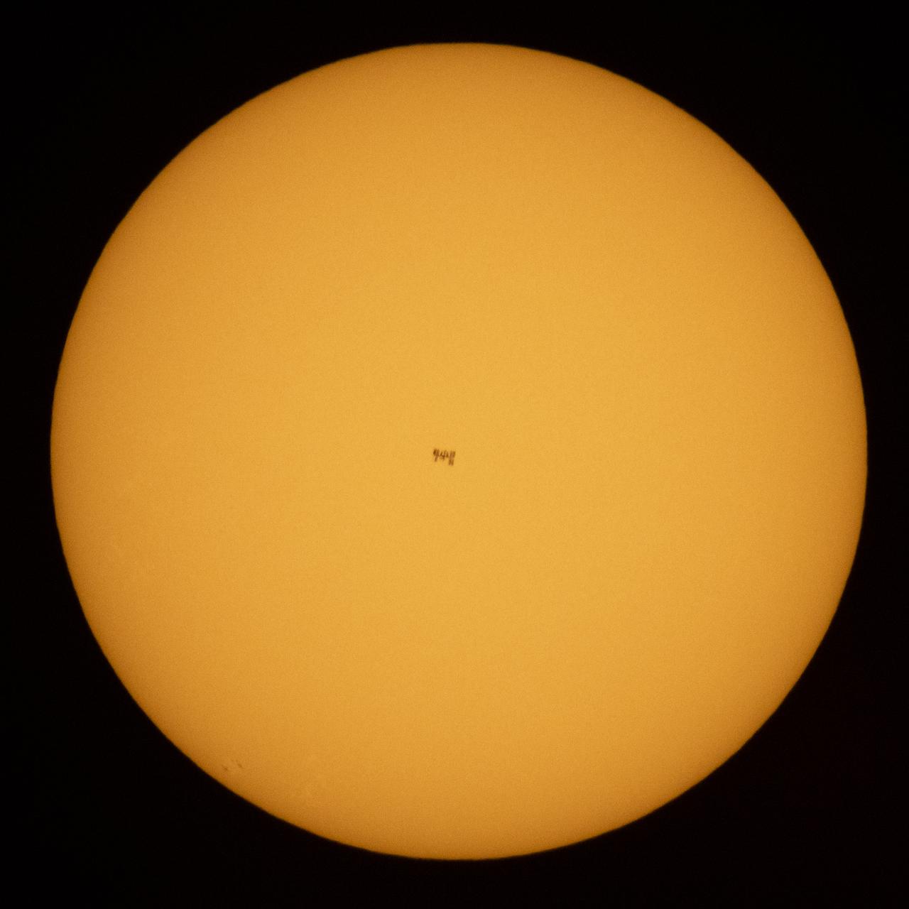 The International Space Station, with a crew of seven onboard, is seen in silhouette as it transits the Sun at roughly five miles per second, Friday, June 25, 2021, from near Nellysford, Va. Onboard are Expedition 65 NASA astronauts Megan McArthur, Mark Vande Hei, Shane Kimbrough, ESA (European Space Agency) astronaut Thomas Pesquet, Japan Aerospace Exploration Agency (JAXA) astronaut Akihiko Hoshide, and Roscosmos cosmonauts Pyotr Dubrov and Oleg Novitskiy. At the time of the transit, Kimbrough and Pesquet were working outside on the station’s port 6 truss to install the second ISS Roll-Out Solar Array (iROSA) on the 4B power channel. Photo Credit: (NASA/Joel Kowsky)