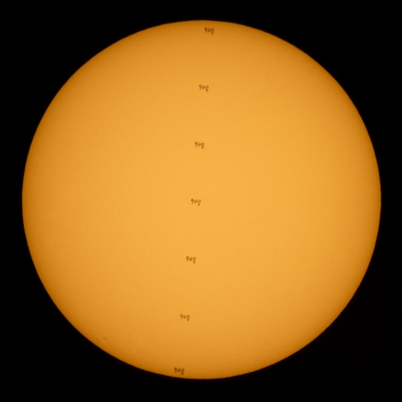 This composite image made from seven frames shows the International Space Station, with a crew of seven onboard, in silhouette as it transits the Sun at roughly five miles per second, Friday, June 25, 2021, from near Nellysford, Va. Onboard are Expedition 65 NASA astronauts Megan McArthur, Mark Vande Hei, Shane Kimbrough, ESA (European Space Agency) astronaut Thomas Pesquet, Japan Aerospace Exploration Agency (JAXA) astronaut Akihiko Hoshide, and Roscosmos cosmonauts Pyotr Dubrov and Oleg Novitskiy. At the time of the transit, Kimbrough and Pesquet were working outside on the station’s port 6 truss to install the second ISS Roll-Out Solar Array (iROSA) on the 4B power channel. Photo Credit: (NASA/Joel Kowsky)