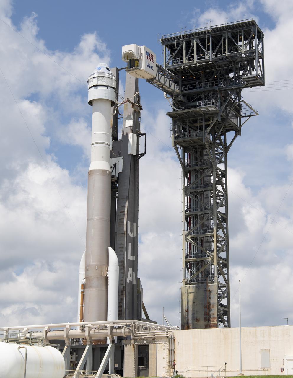 The crew access arm is seen as it swings into position for Boeing’s CST-100 Starliner spacecraft atop a United Launch Alliance Atlas V rocket at the launch pad at Space Launch Complex 41 ahead of the Orbital Flight Test-2 (OFT-2) mission, Thursday, July 29, 2021 at Cape Canaveral Space Force Station in Florida. Boeing’s Orbital Flight Test-2 will be Starliner’s second uncrewed flight test and will dock to the International Space Station as part of NASA's Commercial Crew Program. The mission, currently targeted for launch at 2:53 p.m. EDT Friday, July 30, will serve as an end-to-end test of the system's capabilities. Photo Credit: (NASA/Joel Kowsky)