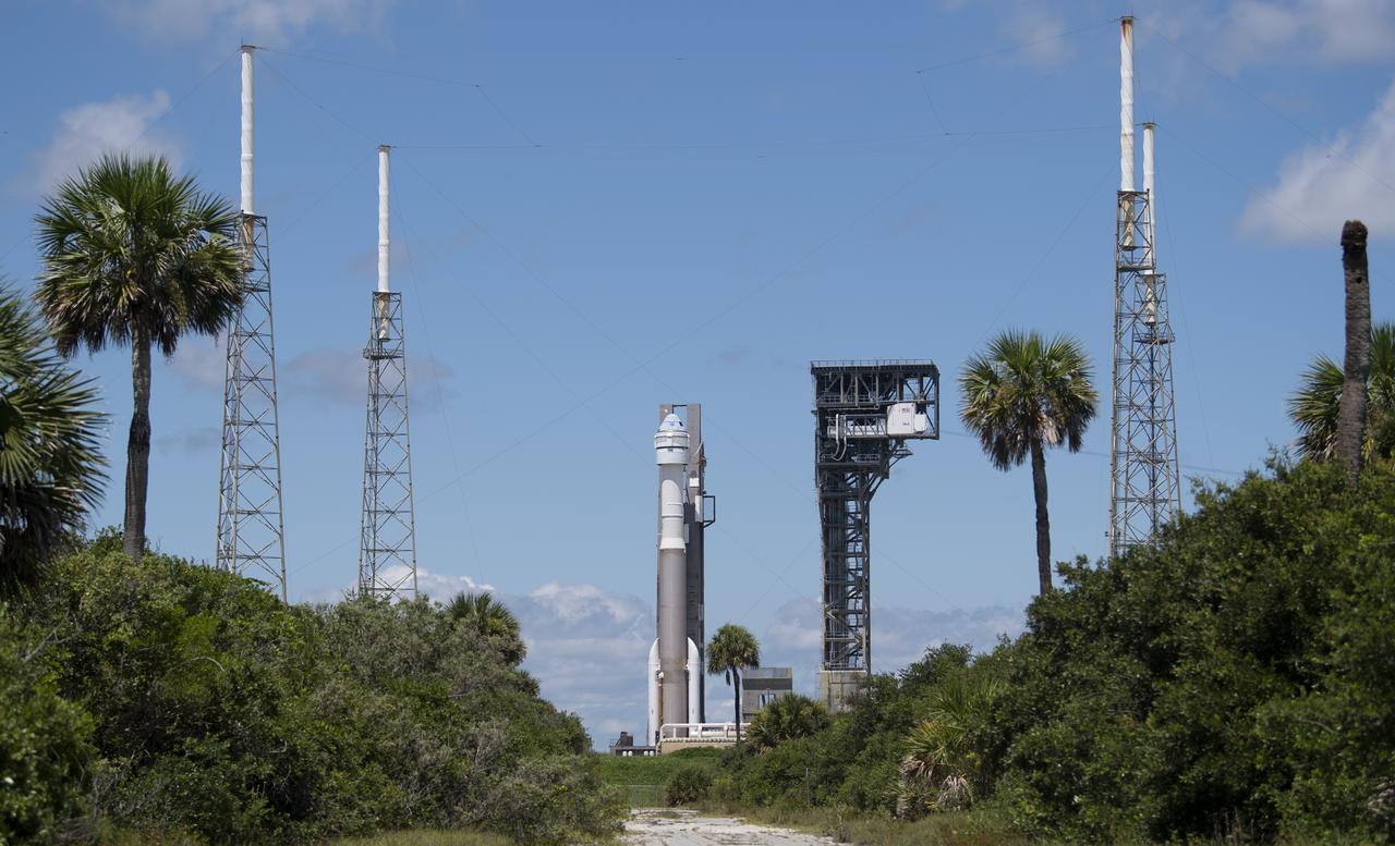 A United Launch Alliance Atlas V rocket with Boeing’s CST-100 Starliner spacecraft aboard is seen as it is rolled back to the Vertical Integration Facility from the launch pad at Space Launch Complex 41 to avoid inclement weather, Friday, July 30, 2021 at Cape Canaveral Space Force Station in Florida. Boeing’s Orbital Flight Test-2 will be Starliner’s second uncrewed flight test and will dock to the International Space Station as part of NASA's Commercial Crew Program. The earliest available launch opportunity is Tuesday, Aug. 3 at 1:20pm ET. Photo Credit: (NASA/Joel Kowsky)