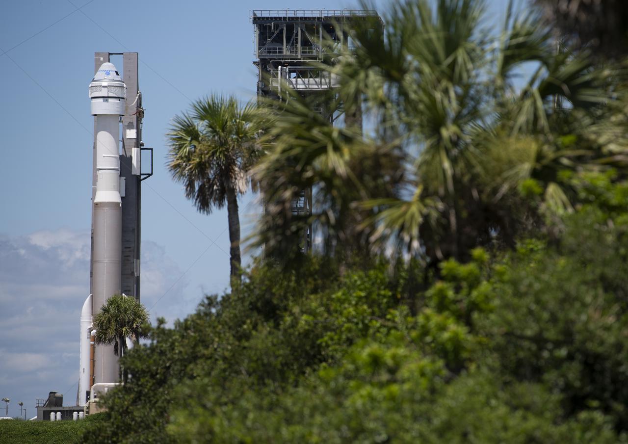 A United Launch Alliance Atlas V rocket with Boeing’s CST-100 Starliner spacecraft aboard is seen as it is rolled back to the Vertical Integration Facility from the launch pad at Space Launch Complex 41 to avoid inclement weather, Friday, July 30, 2021 at Cape Canaveral Space Force Station in Florida. Boeing’s Orbital Flight Test-2 will be Starliner’s second uncrewed flight test and will dock to the International Space Station as part of NASA's Commercial Crew Program. The earliest available launch opportunity is Tuesday, Aug. 3 at 1:20pm ET. Photo Credit: (NASA/Joel Kowsky)