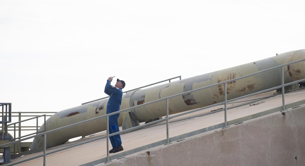 NASA astronaut Barry “Butch” Wilmore takes a picture of a United Launch Alliance Atlas V rocket with Boeing’s CST-100 Starliner spacecraft aboard after it was rolled out of the Vertical Integration Facility to the launch pad at Space Launch Complex 41 ahead of the Orbital Flight Test-2 (OFT-2) mission, Monday, Aug. 2, 2021 at Cape Canaveral Space Force Station in Florida. Boeing’s Orbital Flight Test-2 will be Starliner’s second uncrewed flight test and will dock to the International Space Station as part of NASA's Commercial Crew Program. The mission, currently targeted for launch at 1:20 p.m. EDT Tuesday, Aug. 3, will serve as an end-to-end test of the system's capabilities. Wilmore is scheduled to fly aboard Starliner’s Crewed Flight Test mission.  Photo Credit: (NASA/Joel Kowsky)
