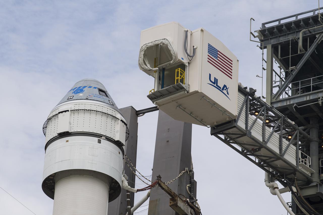 The crew access arm is seen as it swings into position for Boeing’s CST-100 Starliner spacecraft atop a United Launch Alliance Atlas V rocket at the launch pad at Space Launch Complex 41 ahead of the Orbital Flight Test-2 (OFT-2) mission, Monday, Aug. 2, 2021 at Cape Canaveral Space Force Station in Florida. Boeing’s Orbital Flight Test-2 will be Starliner’s second uncrewed flight test and will dock to the International Space Station as part of NASA's Commercial Crew Program. The mission, currently targeted for launch at 1:20 p.m. EDT Tuesday, Aug. 3, will serve as an end-to-end test of the system's capabilities. Photo Credit: (NASA/Aubrey Gemignani)