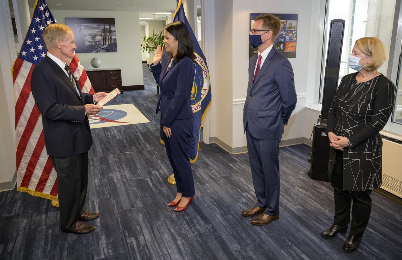 NASA Administrator Bill Nelson, left, swears in Margaret Vo Schaus as NASA's Chief Financial Officer, as her husband John Schaus and NASA Deputy Administrator Pam Melroy, right, look on, Wednesday, Aug. 4, 2021, at the Mary W. Jackson NASA Headquarters building in Washington. Photo Credit: (NASA/Bill Ingalls)