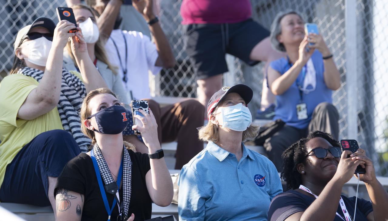 NASA Deputy Administrator Pam Melroy, center, watches as a Northrop Grumman Antares rocket carrying a Cygnus resupply spacecraft launches from  Pad-0A of the Mid-Atlantic Regional Spaceport, Tuesday, Aug. 10, 2021, at NASA's Wallops Flight Facility in Virginia. Northrop Grumman’s 16th contracted cargo resupply mission with NASA will deliver nearly 8,200 pounds of science and research, crew supplies and vehicle hardware to the International Space Station and its crew.  Photo Credit: (NASA/Joel Kowsky)