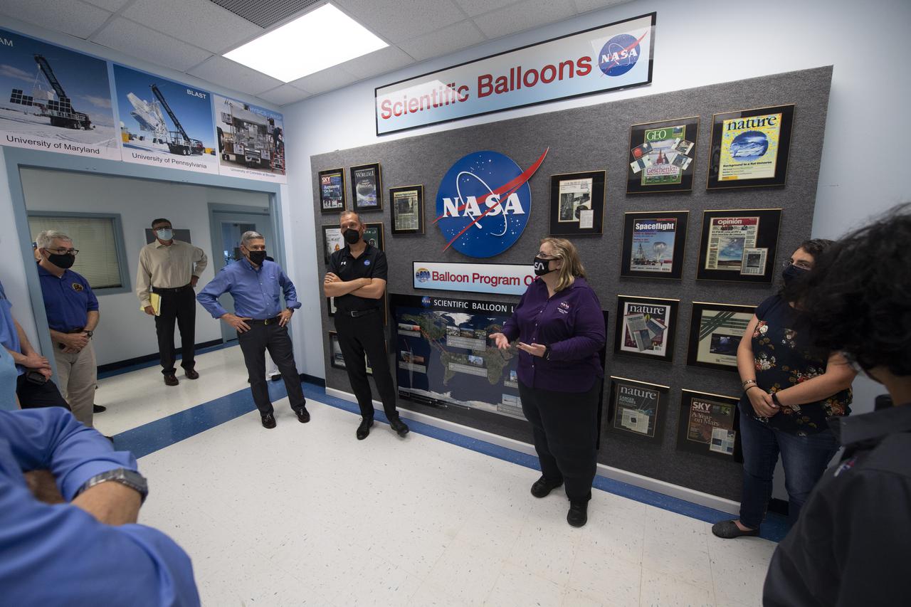 Debbie Fairbrother, chief of the Balloon Program Office at NASA's Wallops Flight Facility, center, speaks with Thomas Zurbuchen, associate administrator for NASA's Science Mission Directorate, Bob Cabana, NASA associate administrator, Dave Pierce, director of NASA's Wallops Flight Facility, NASA Administrator Bill Nelson, NASA Deputy Administrator Pam Melroy, and Dennis Andrucyk, director of NASA's Goddard Space Flight Center during a tour the Small Satellites, Balloon Research and Development Lab, Tuesday, Aug. 10, 2021, NASA’s Wallops Flight Facility in Virginia. Photo Credit: (NASA/Joel Kowsky)
