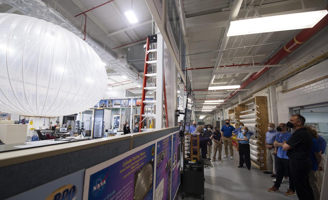 Debbie Fairbrother, chief of the Balloon Program Office at NASA's Wallops Flight Facility, center, speaks with Thomas Zurbuchen, associate administrator for NASA's Science Mission Directorate, Bob Cabana, NASA associate administrator, Dave Pierce, director of NASA's Wallops Flight Facility, NASA Administrator Bill Nelson, NASA Deputy Administrator Pam Melroy, and Dennis Andrucyk, director of NASA's Goddard Space Flight Center during a tour the Small Satellites, Balloon Research and Development Lab, Tuesday, Aug. 10, 2021, at NASA’s Wallops Flight Facility in Virginia. Photo Credit: (NASA/Joel Kowsky)