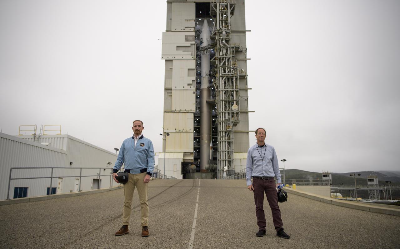 Actor Marc Evan Jackson, left, and NASA Landsat 9 Project Scientist Jeff Masek pose for a photograph by the United Launch Alliance (ULA) Atlas V rocket with the Landsat 9 satellite onboard, Sunday, Sept. 26, 2021, at Vandenberg Space Force Base in California. The Landsat 9 satellite, a joint NASA/U.S. Geological Survey mission that will continue the legacy of monitoring Earth’s land and coastal regions, is scheduled for liftoff Monday, Sept. 27. Photo Credit: (NASA/Bill Ingalls)