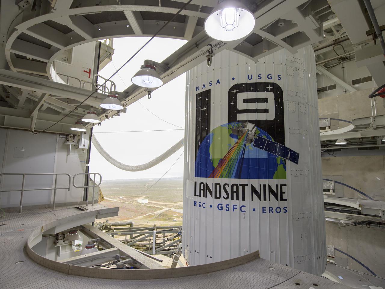 The United Launch Alliance (ULA) Atlas V rocket with the Landsat 9 satellite onboard is seen, Sunday, Sept. 26, 2021, at Vandenberg Space Force Base in California. The Landsat 9 satellite, a joint NASA/U.S. Geological Survey mission that will continue the legacy of monitoring Earth’s land and coastal regions, is scheduled for liftoff Monday, Sept. 27. Photo Credit: (NASA/Bill Ingalls)