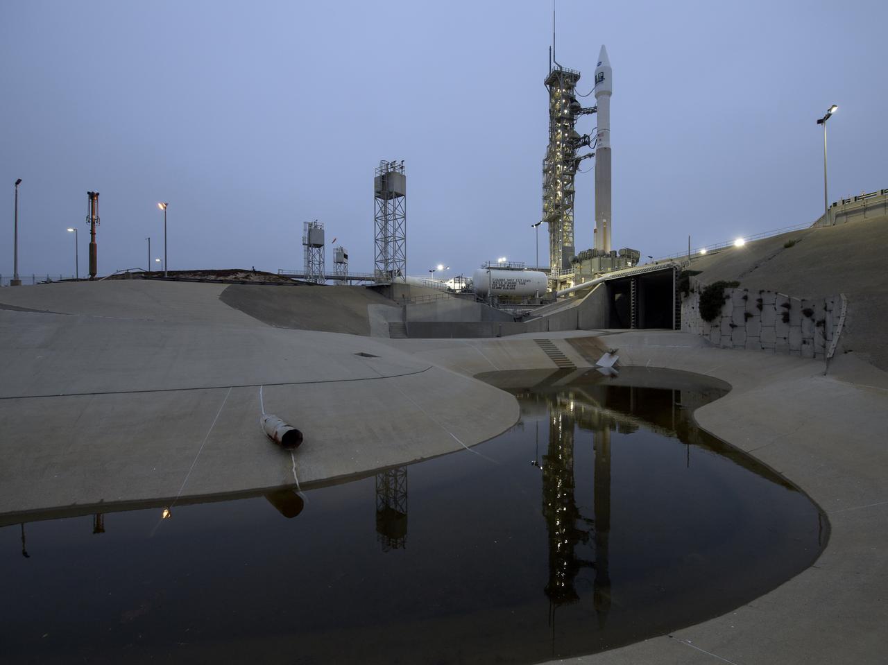 The United Launch Alliance (ULA) Atlas V rocket with the Landsat 9 satellite onboard is seen, Monday, Sept. 27, 2021, after the mobile launcher platform (MLP) was rolled back at Vandenberg Space Force Base in California. The Landsat 9 satellite is a joint NASA/U.S. Geological Survey mission that will continue the legacy of monitoring Earth’s land and coastal regions. Photo Credit: (NASA/Bill Ingalls)