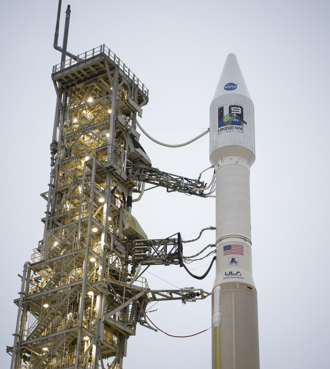 The United Launch Alliance (ULA) Atlas V rocket with the Landsat 9 satellite onboard is seen, Monday, Sept. 27, 2021, after the mobile launcher platform (MLP) was rolled back at Vandenberg Space Force Base in California. The Landsat 9 satellite is a joint NASA/U.S. Geological Survey mission that will continue the legacy of monitoring Earth’s land and coastal regions. Photo Credit: (NASA/Bill Ingalls)