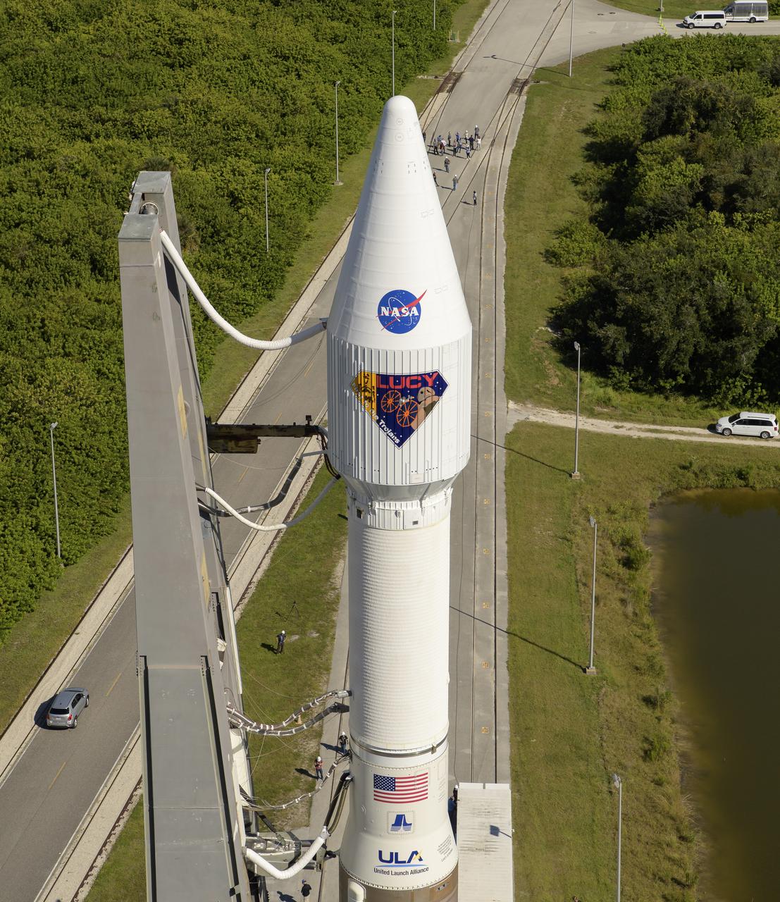 A United Launch Alliance Atlas V rocket with the Lucy spacecraft aboard is seen as it is rolled out of the Vertical Integration Facility to the launch pad at Space Launch Complex 41, Thursday, Oct. 14, 2021, at Cape Canaveral Space Force Station in Florida. Lucy will be the first spacecraft to study Jupiter's Trojan Asteroids. Like the mission's namesake – the fossilized human ancestor, "Lucy," whose skeleton provided unique insight into humanity's evolution – Lucy will revolutionize our knowledge of planetary origins and the formation of the solar system. Photo Credit: (NASA/Bill Ingalls)