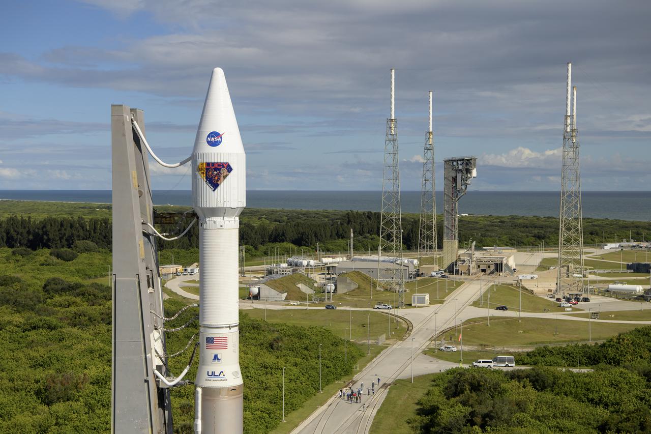 A United Launch Alliance Atlas V rocket with the Lucy spacecraft aboard is seen as it is rolled out of the Vertical Integration Facility to the launch pad at Space Launch Complex 41, Thursday, Oct. 14, 2021, at Cape Canaveral Space Force Station in Florida. Lucy will be the first spacecraft to study Jupiter's Trojan Asteroids. Like the mission's namesake – the fossilized human ancestor, "Lucy," whose skeleton provided unique insight into humanity's evolution – Lucy will revolutionize our knowledge of planetary origins and the formation of the solar system. Photo Credit: (NASA/Bill Ingalls)