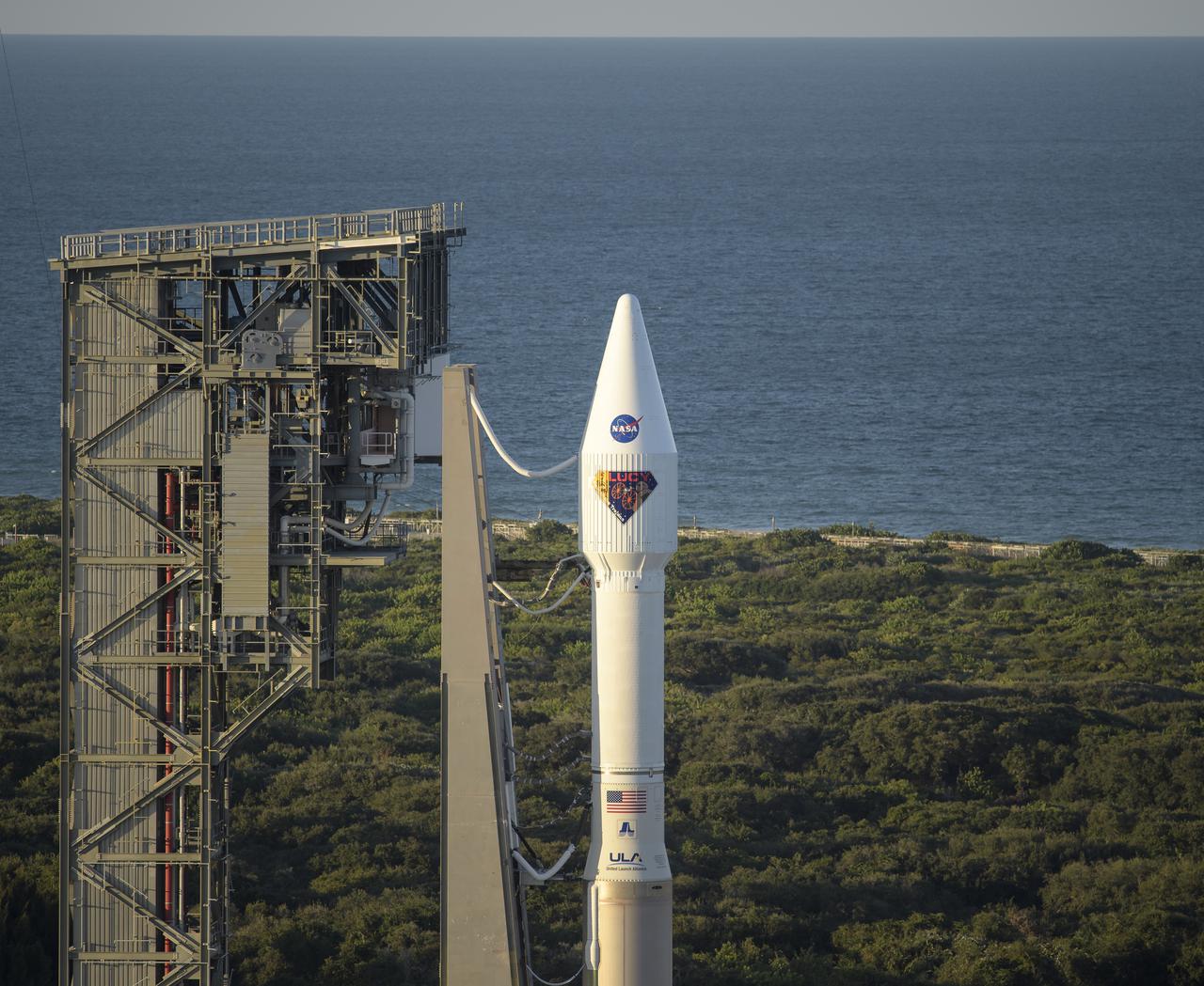 A United Launch Alliance Atlas V rocket with the Lucy spacecraft aboard is seen at Space Launch Complex 41, Friday, Oct. 15, 2021, at Cape Canaveral Space Force Station in Florida. Lucy will be the first spacecraft to study Jupiter's Trojan Asteroids. Like the mission's namesake – the fossilized human ancestor, "Lucy," whose skeleton provided unique insight into humanity's evolution – Lucy will revolutionize our knowledge of planetary origins and the formation of the solar system. Photo Credit: (NASA/Bill Ingalls)